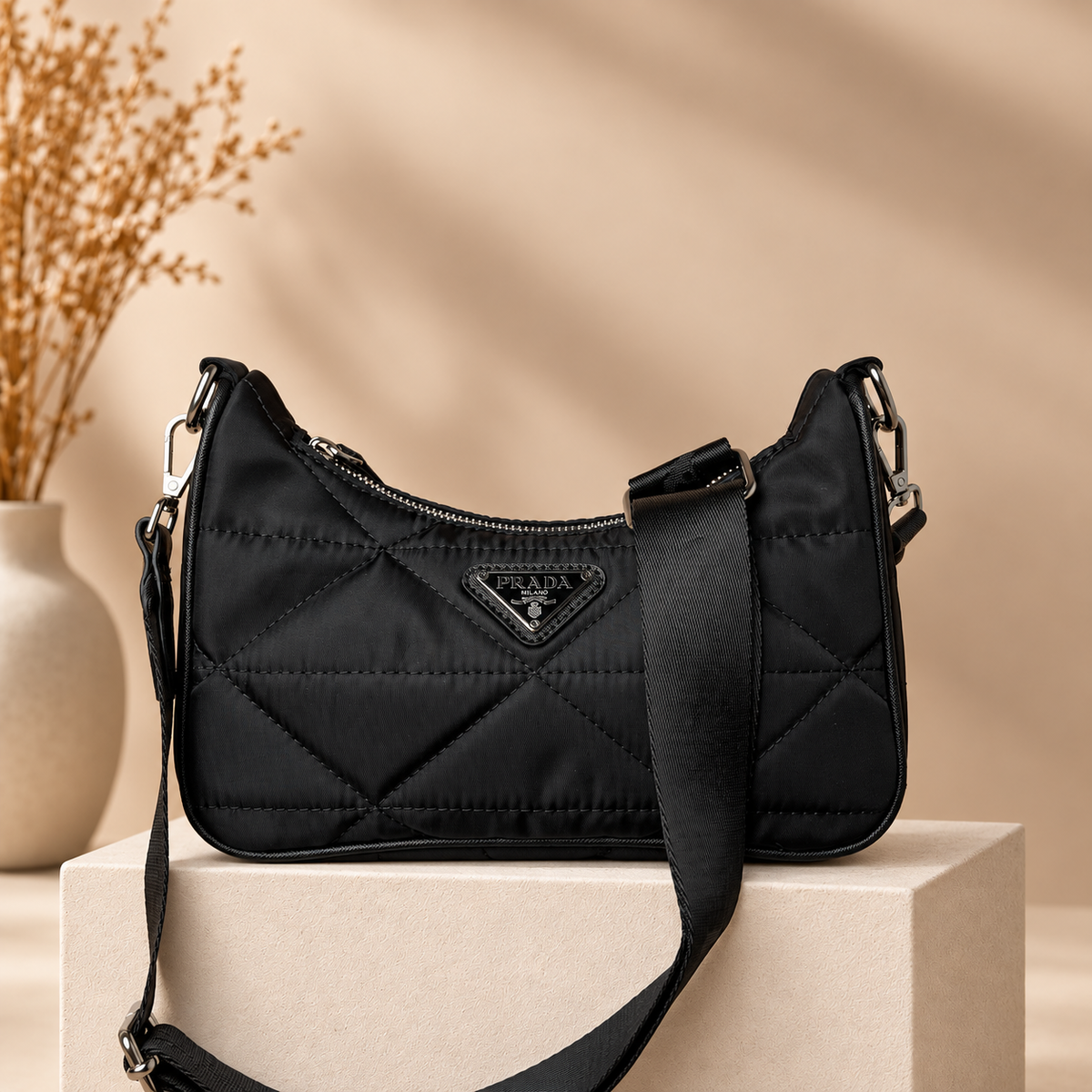 B03 black quilted shoulder bag on warm beige studio pedestal