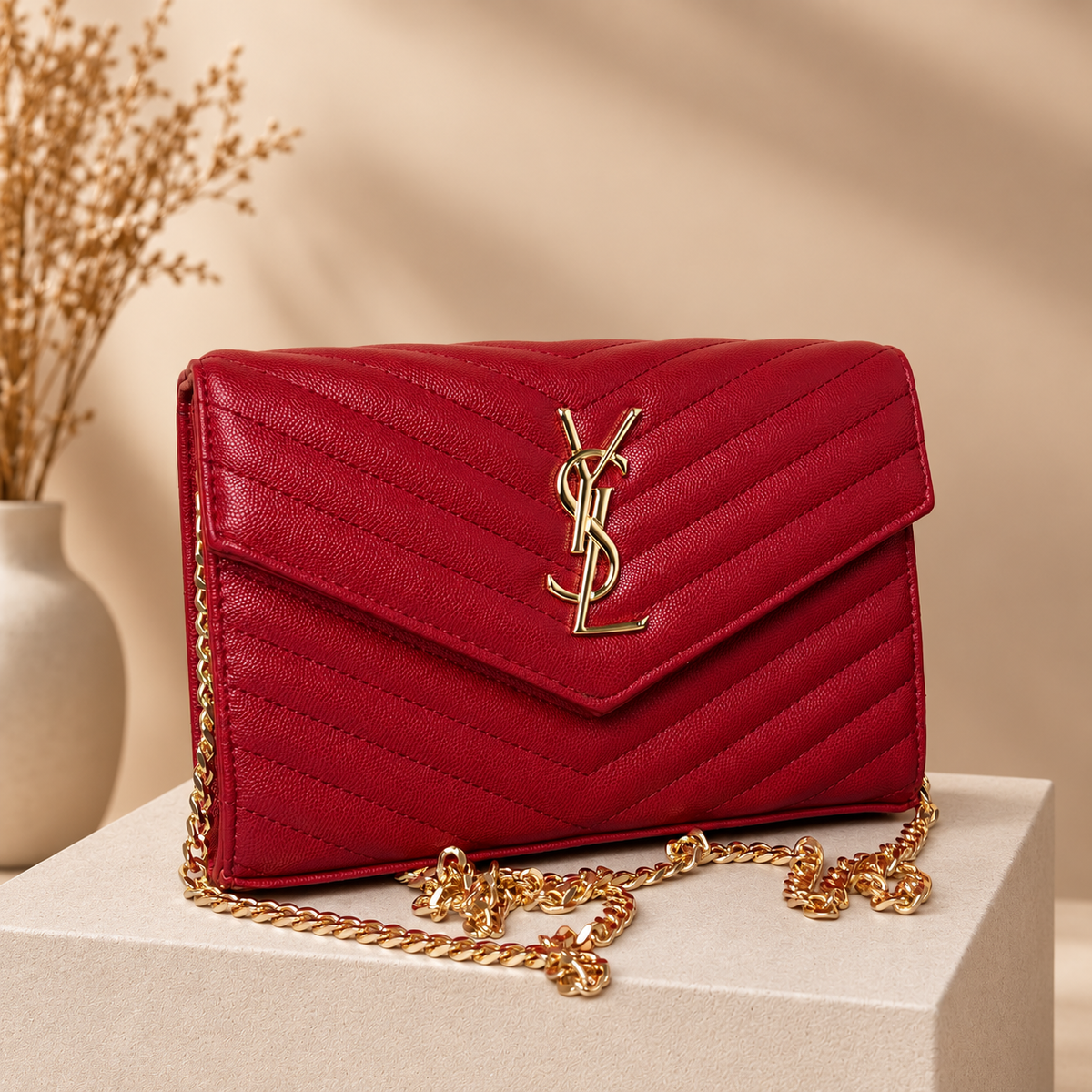 B04 red envelope handbag on warm beige studio pedestal